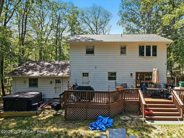 a view of swimming pool with lawn chairs and plants