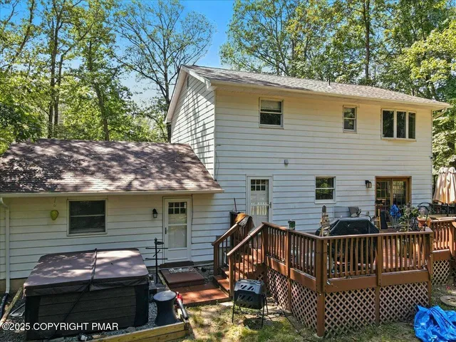 a aerial view of a house with swimming pool next to a yard