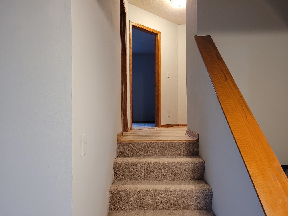 960 South Trainer Road Rockford, IL 61108 - Photo 12 of 31 a view of staircase with white walls and black door