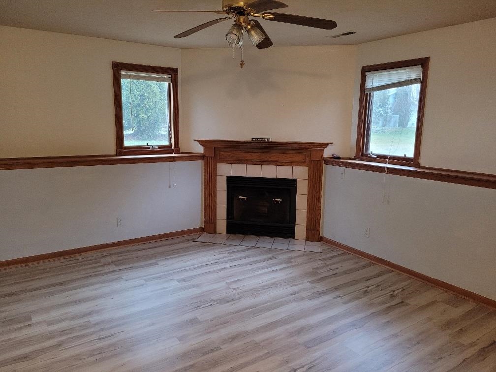 960 South Trainer Road Rockford, IL 61108 - Photo 23 of 31 an empty room with a fireplace and windows