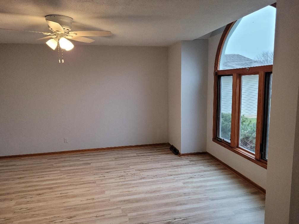 960 South Trainer Road Rockford, IL 61108 - Photo 4 of 31 an empty room with wooden floor fan and window