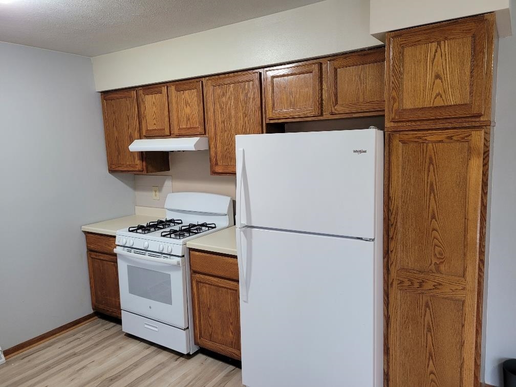 960 South Trainer Road Rockford, IL 61108 - Photo 9 of 31 a white refrigerator freezer and a stove sitting inside of a kitchen