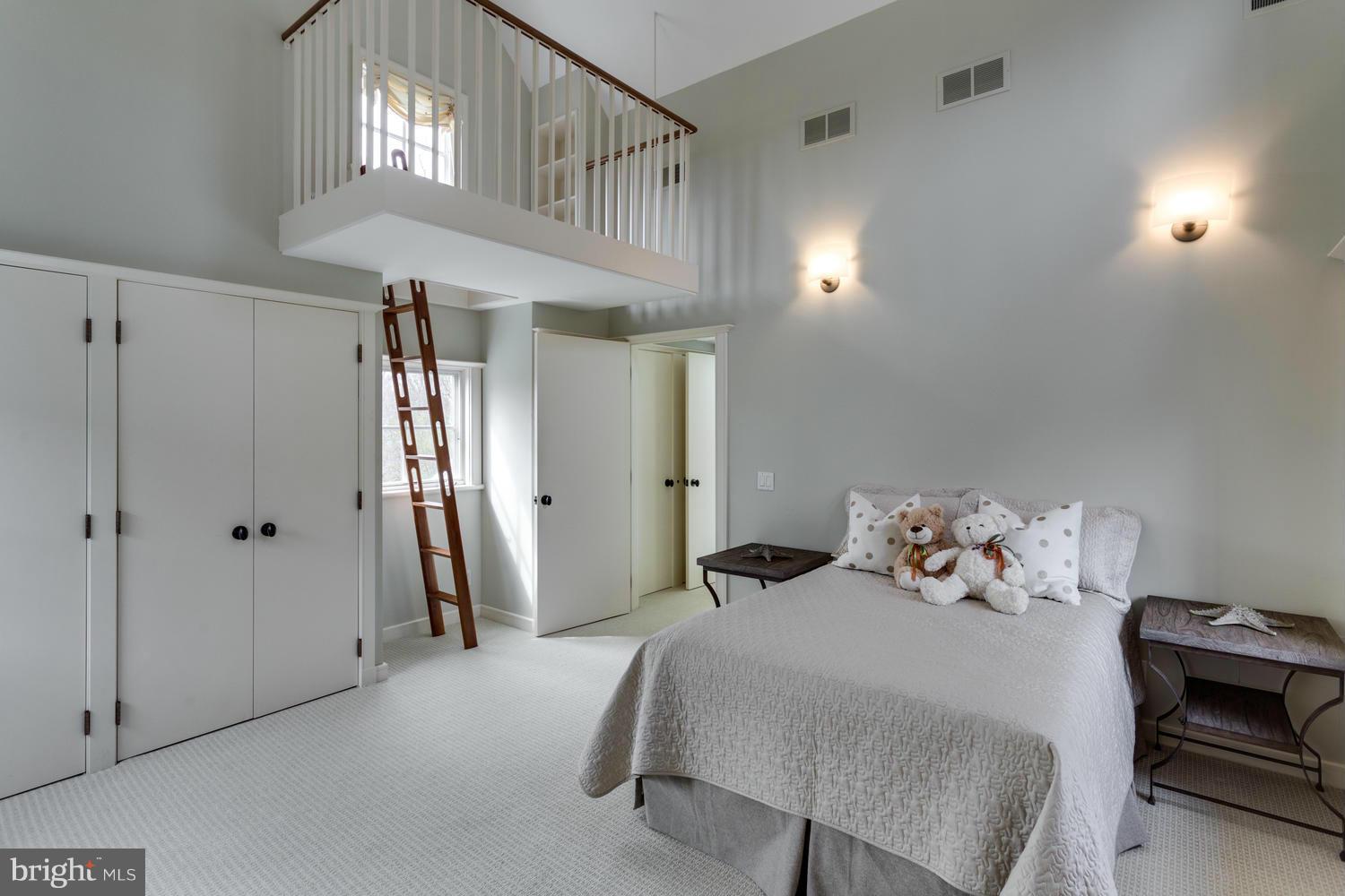 1300 Ranleigh Road McLean, VA 22101 - Photo 17 of 30 a bedroom with a bed a chandelier and a walk in closet
