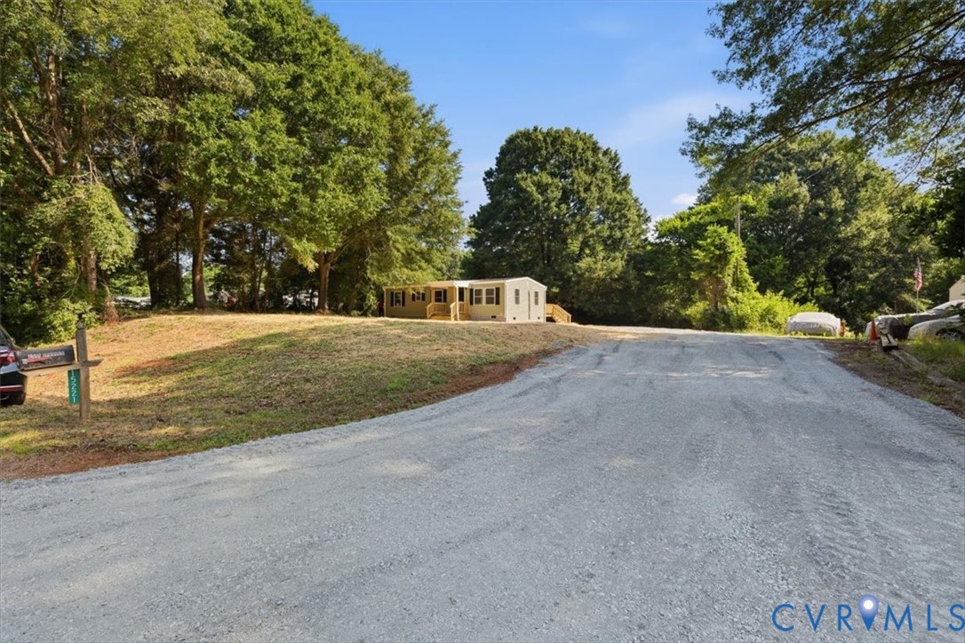 15221 Wright Road Amelia Court House, VA 23002 - Photo 20 of 22 Gravel driveway ascending to a single-story reside