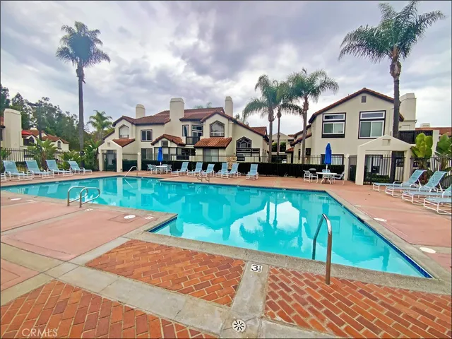 a front view of a house with garden and patio