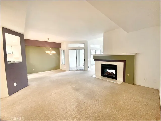 a view of an empty room with a fireplace