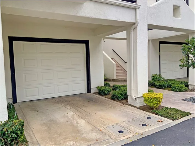 front view of a house with potted plants