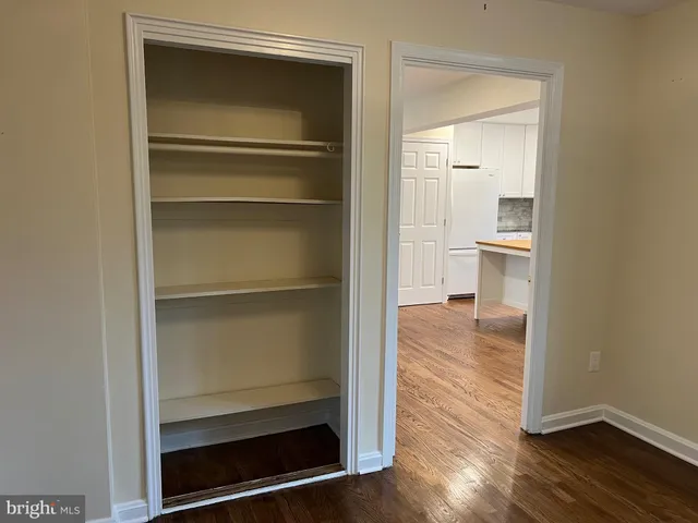 a view of a room with wooden floor