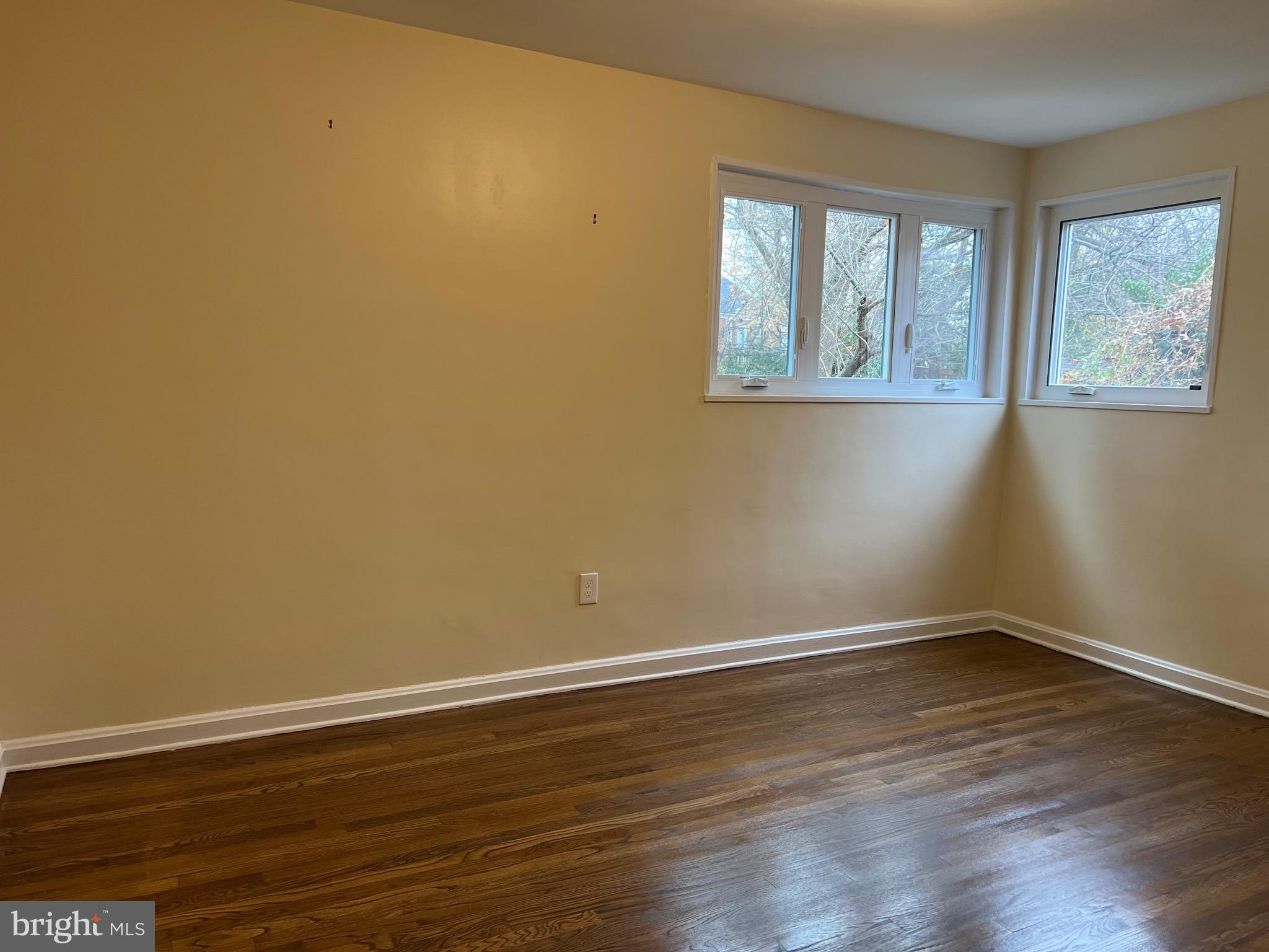 10713 St Margarets Way Silver Spring, MD 20902 - Photo 9 of 20 a view of empty room with wooden floor and fan