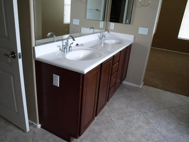 a bathroom with a double vanity sink and a mirror