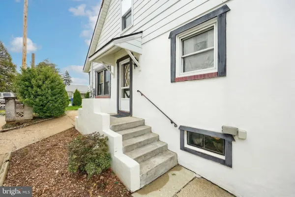 a view of front door of house with stairs