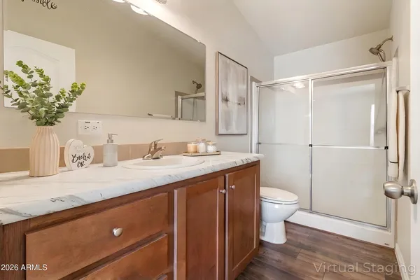 a bathroom with a granite countertop sink toilet and shower