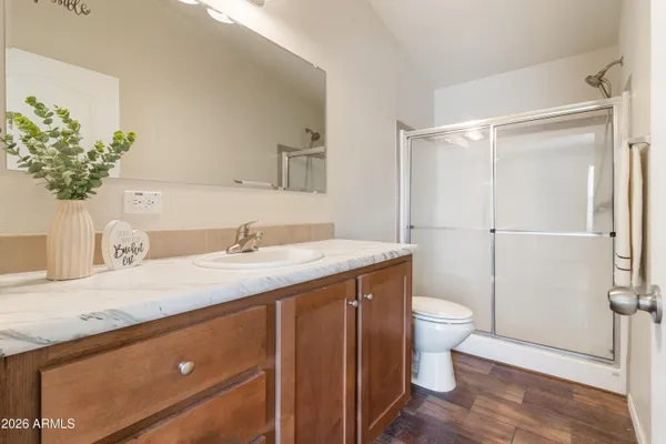 a bathroom with a granite countertop sink toilet and shower