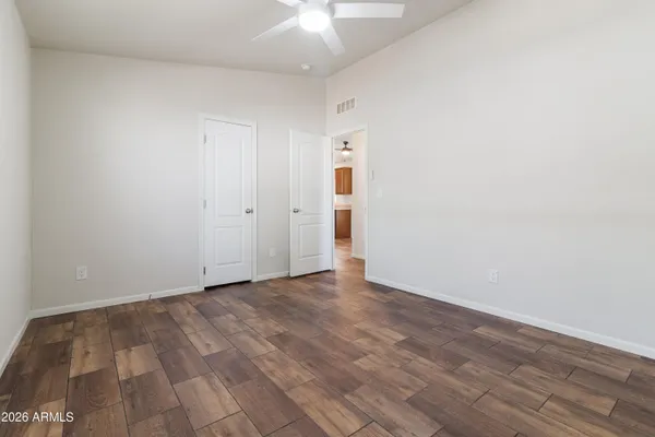 a view of an empty room with wooden floor