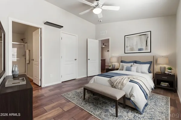 a bedroom with a bed and wooden floor