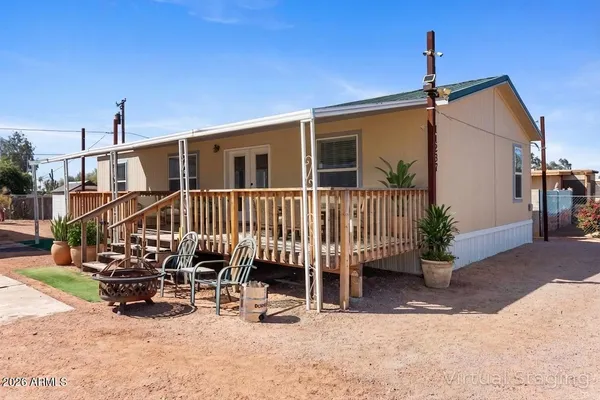 a view of a house with a patio and wooden deck