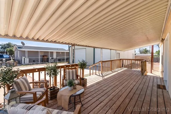 a view of a patio with couches and chairs with wooden floor