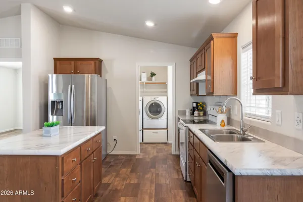 a kitchen with a sink stove and refrigerator