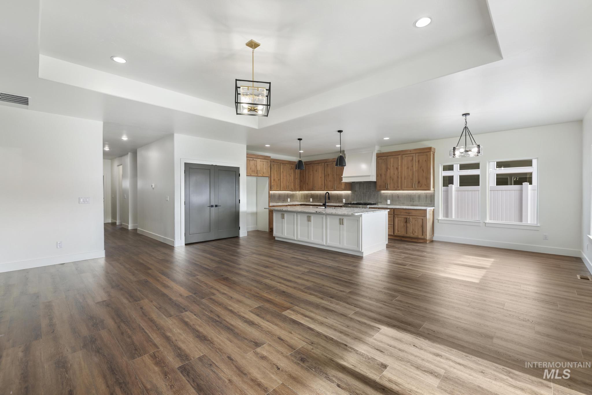 527 Falling Leaf Lane Twin Falls, ID 83301 - Photo 42 of 42 Kitchen with open floor plan, recessed lighting, brown cabinets, a chandelier, and an island with sink