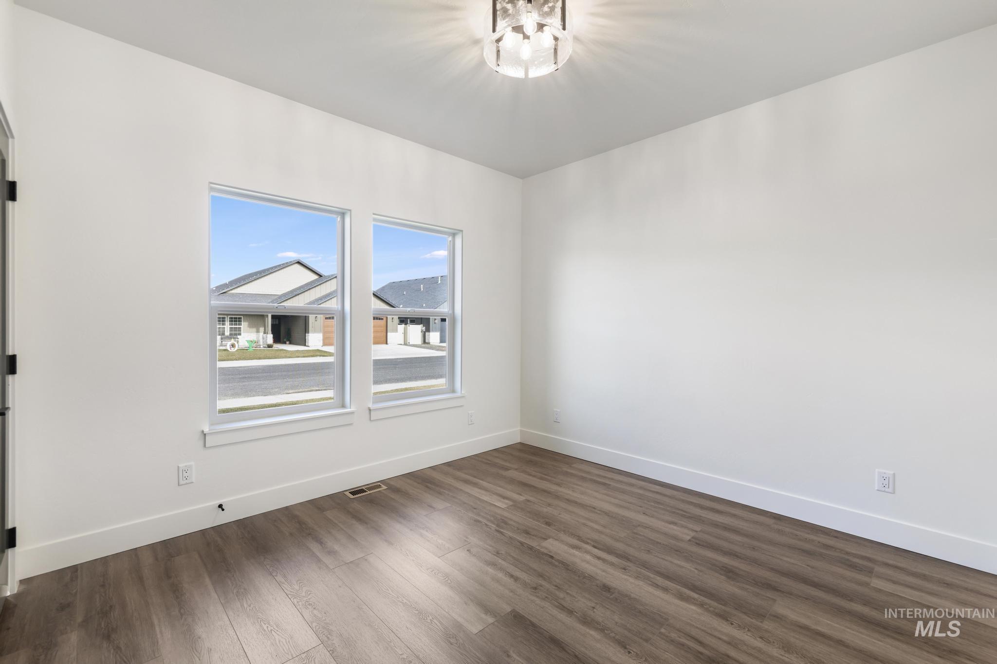 527 Falling Leaf Lane Twin Falls, ID 83301 - Photo 17 of 42 Spare room with dark wood-style flooring and baseboards