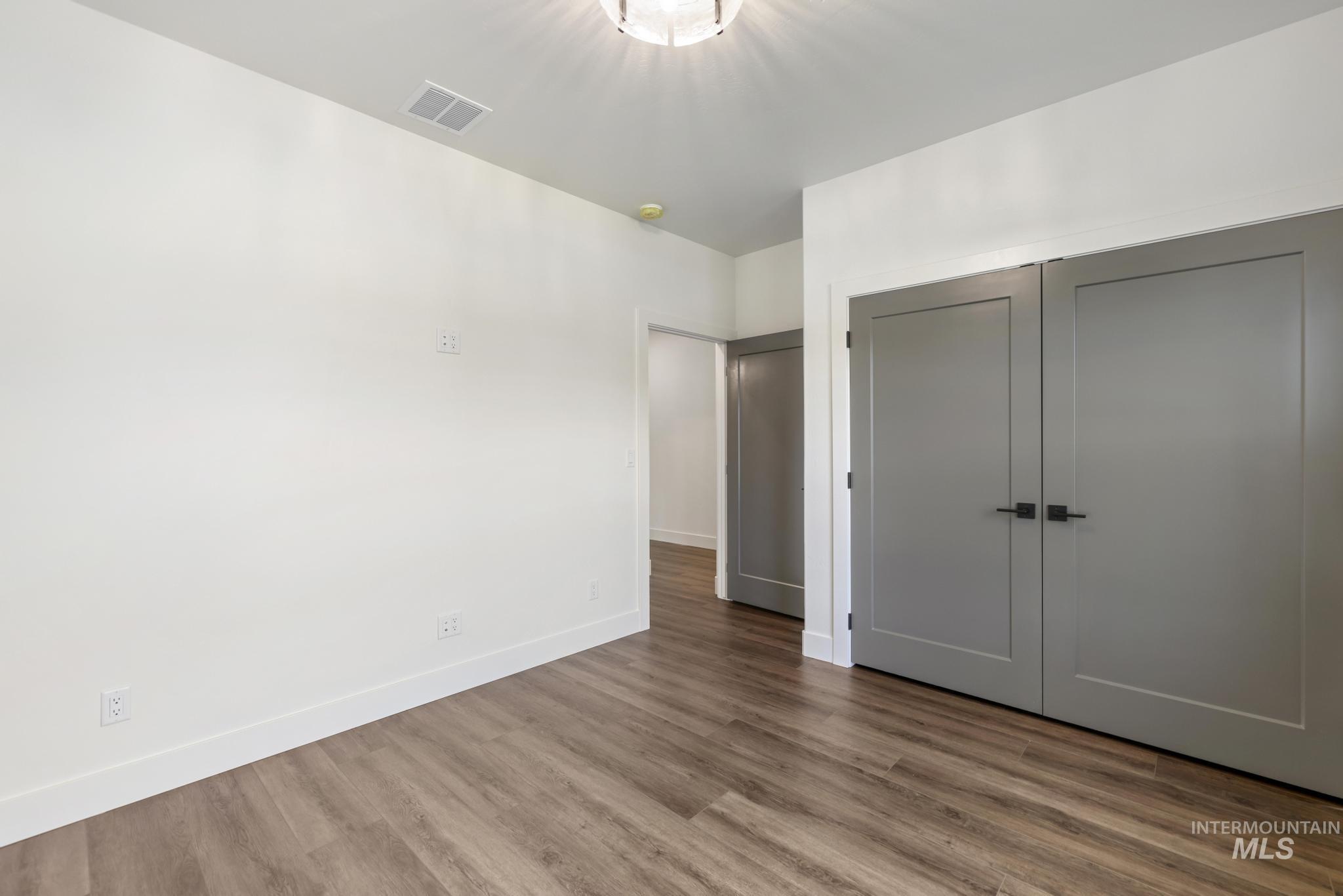 527 Falling Leaf Lane Twin Falls, ID 83301 - Photo 18 of 42 Unfurnished bedroom with a closet and wood finished floors