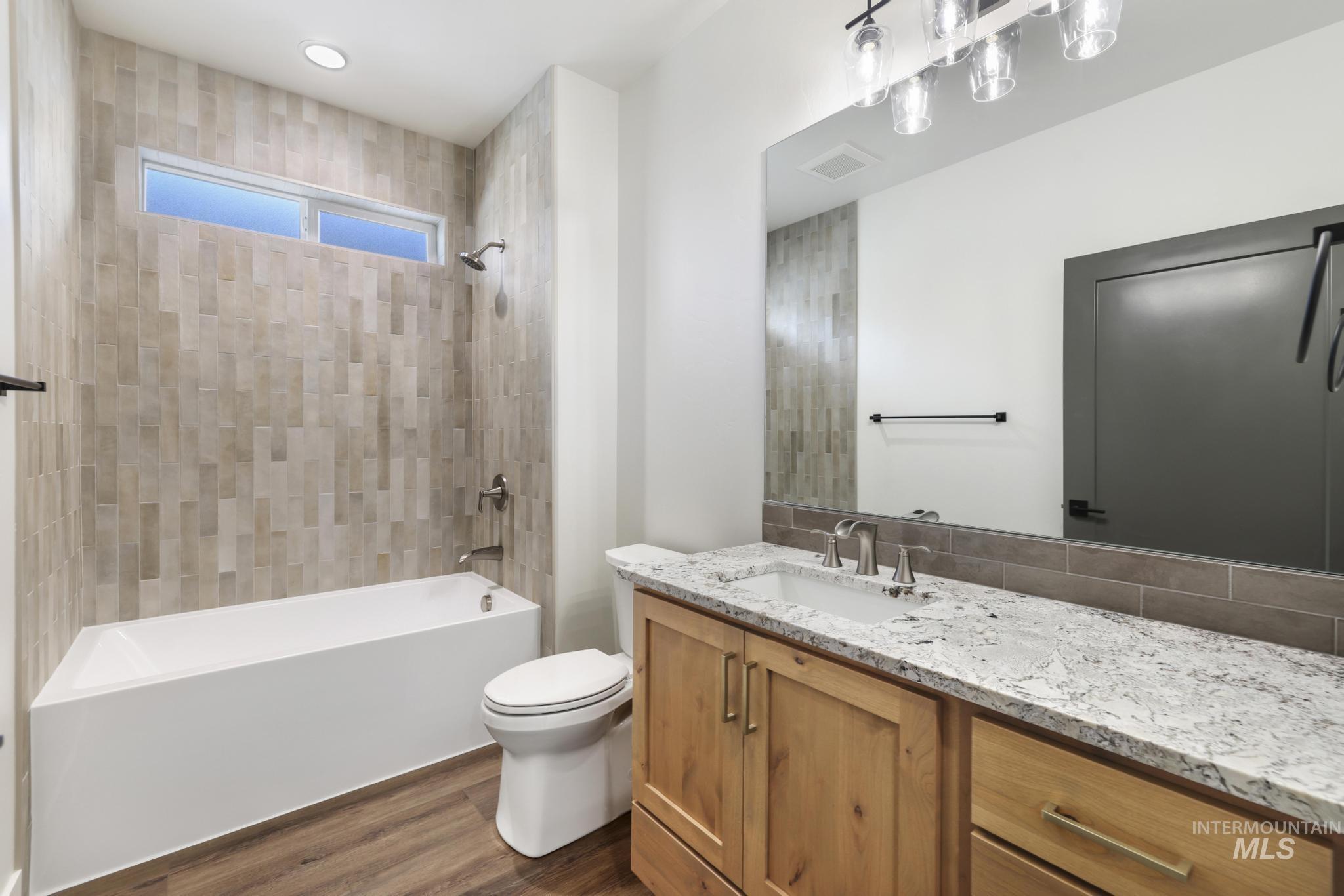 527 Falling Leaf Lane Twin Falls, ID 83301 - Photo 19 of 42 Bathroom with vanity, bathtub / shower combination, and dark wood finished floors