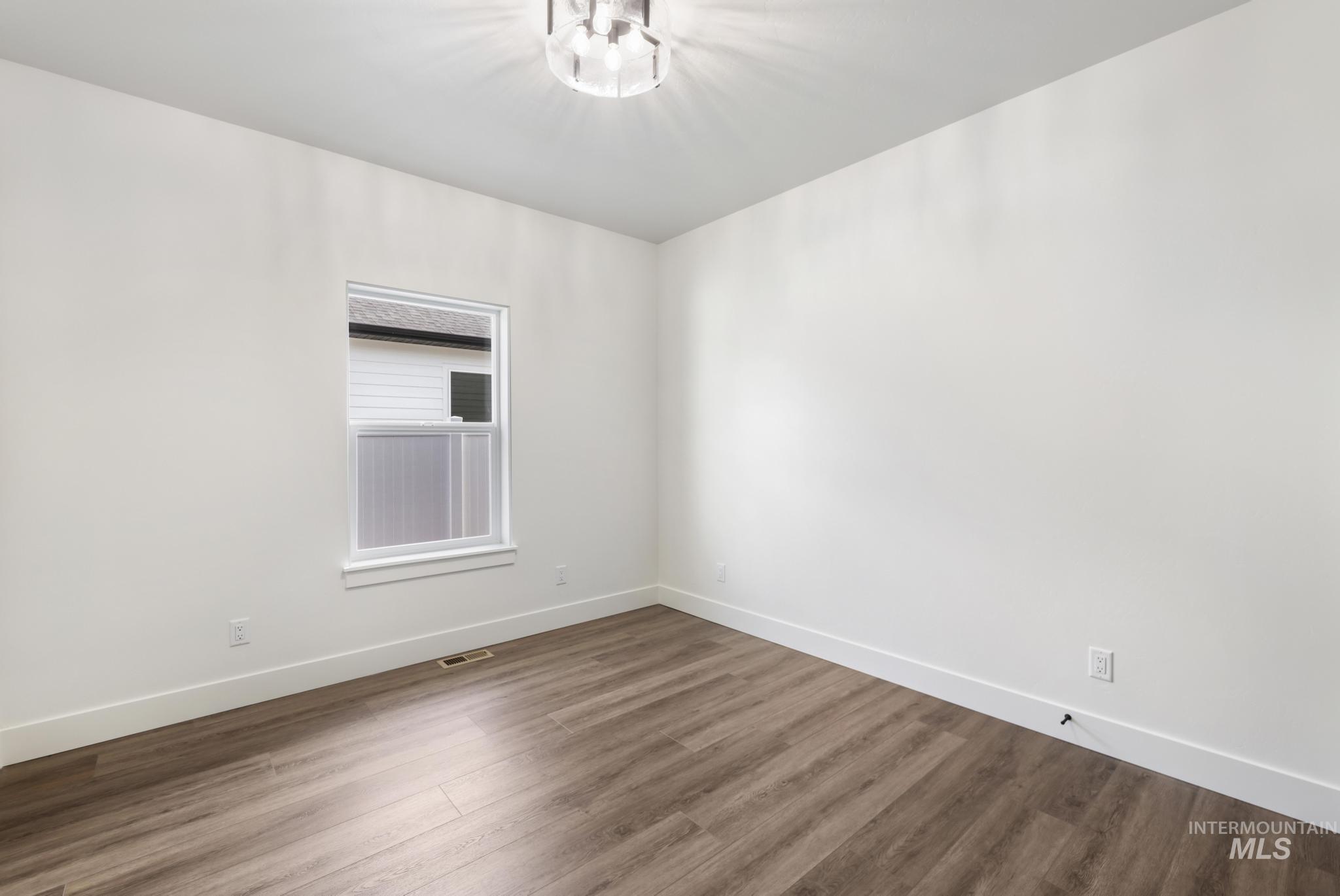 527 Falling Leaf Lane Twin Falls, ID 83301 - Photo 20 of 42 Unfurnished room with baseboards and dark wood-style floors