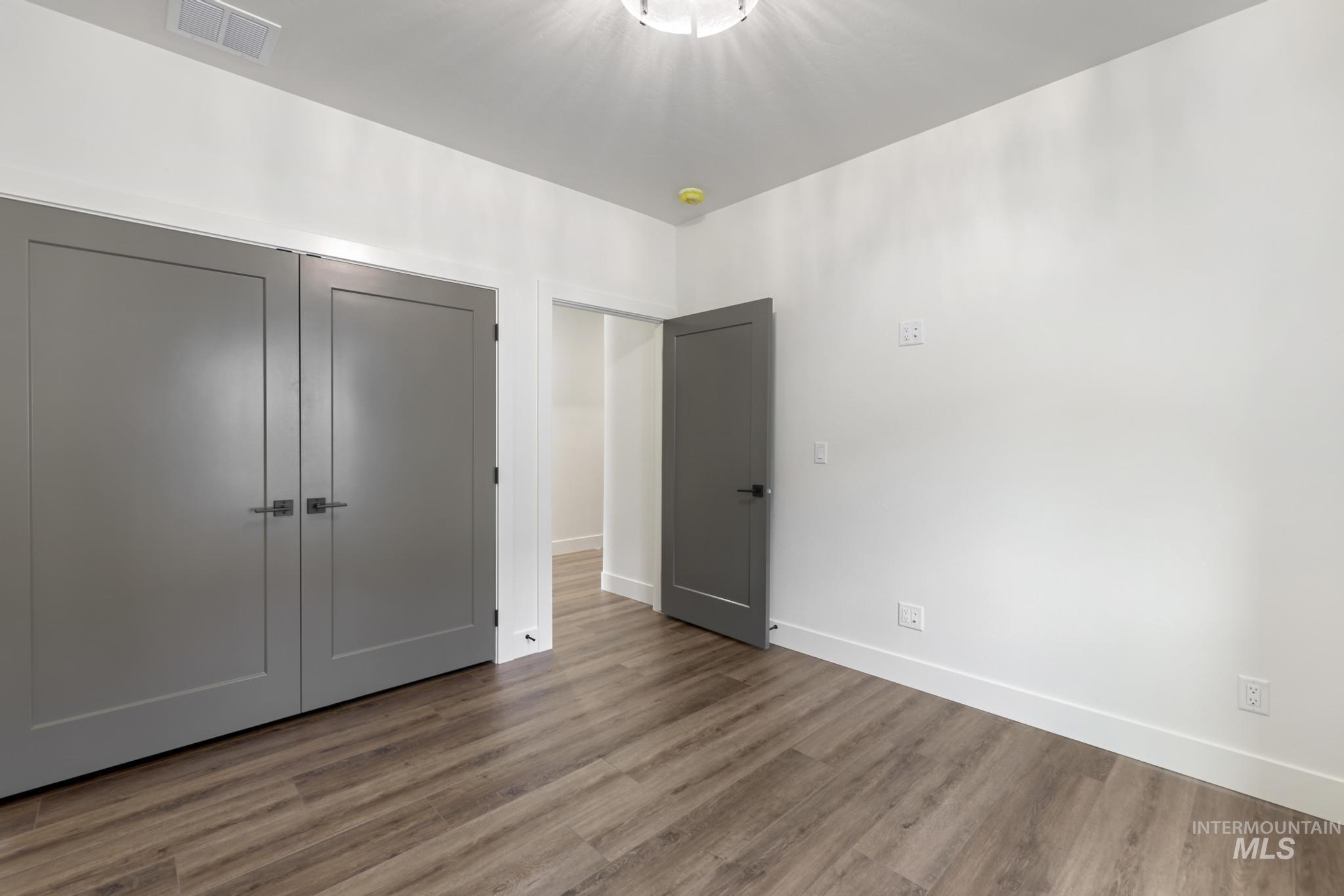 527 Falling Leaf Lane Twin Falls, ID 83301 - Photo 21 of 42 Unfurnished bedroom featuring a closet and wood finished floors