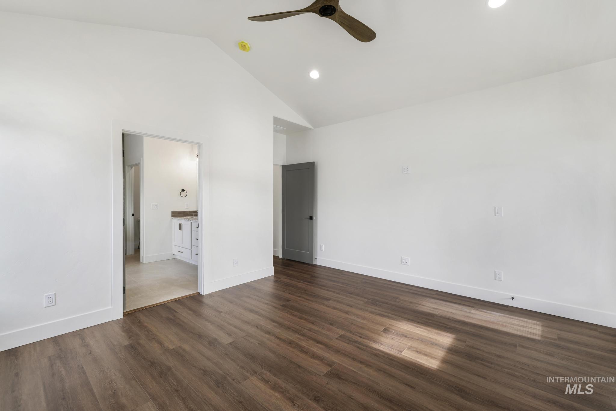 527 Falling Leaf Lane Twin Falls, ID 83301 - Photo 23 of 42 Unfurnished bedroom with ensuite bath, ceiling fan, dark wood-type flooring, recessed lighting, and high vaulted ceiling