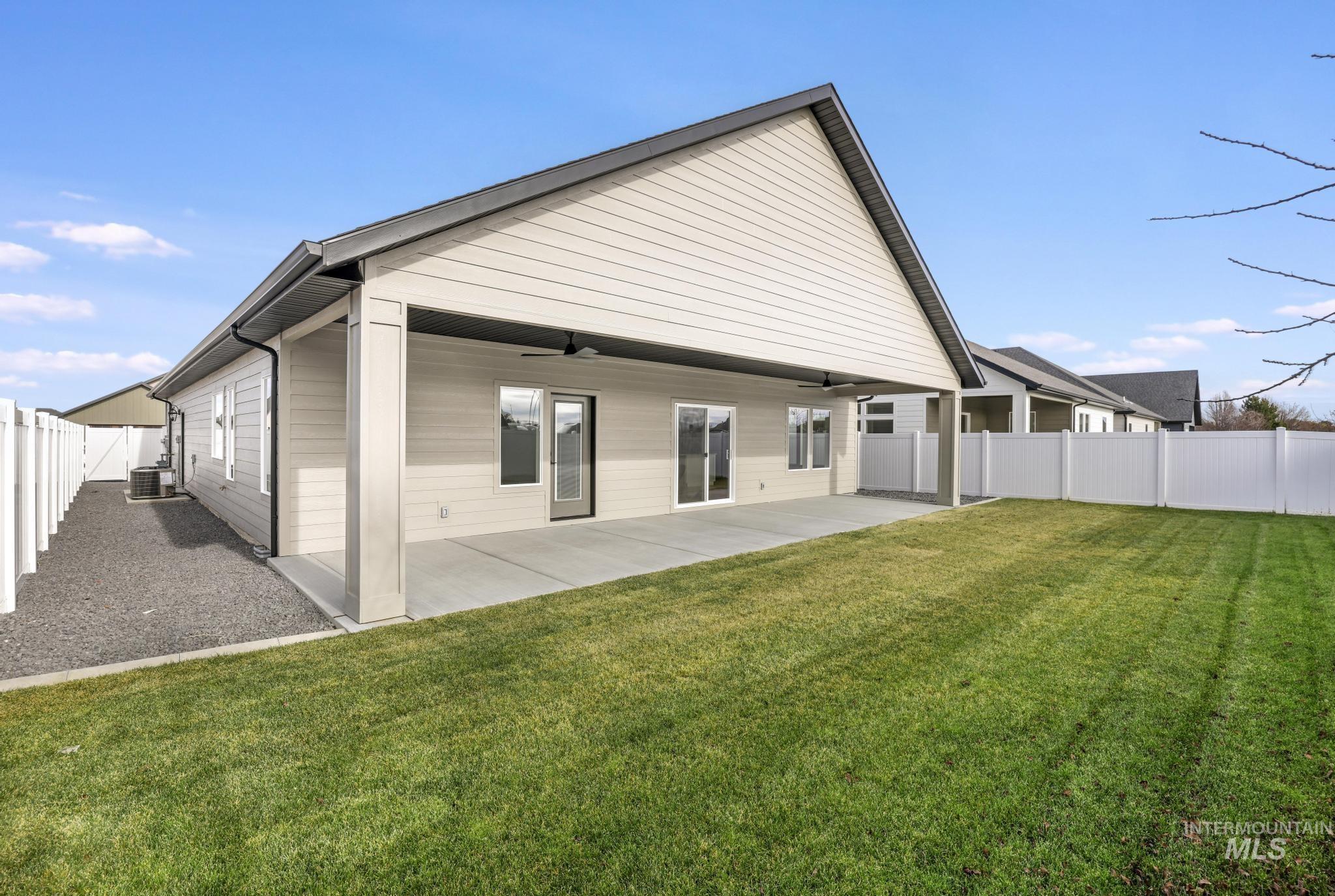 527 Falling Leaf Lane Twin Falls, ID 83301 - Photo 32 of 42 Back of property with a fenced backyard, ceiling fan, and a patio