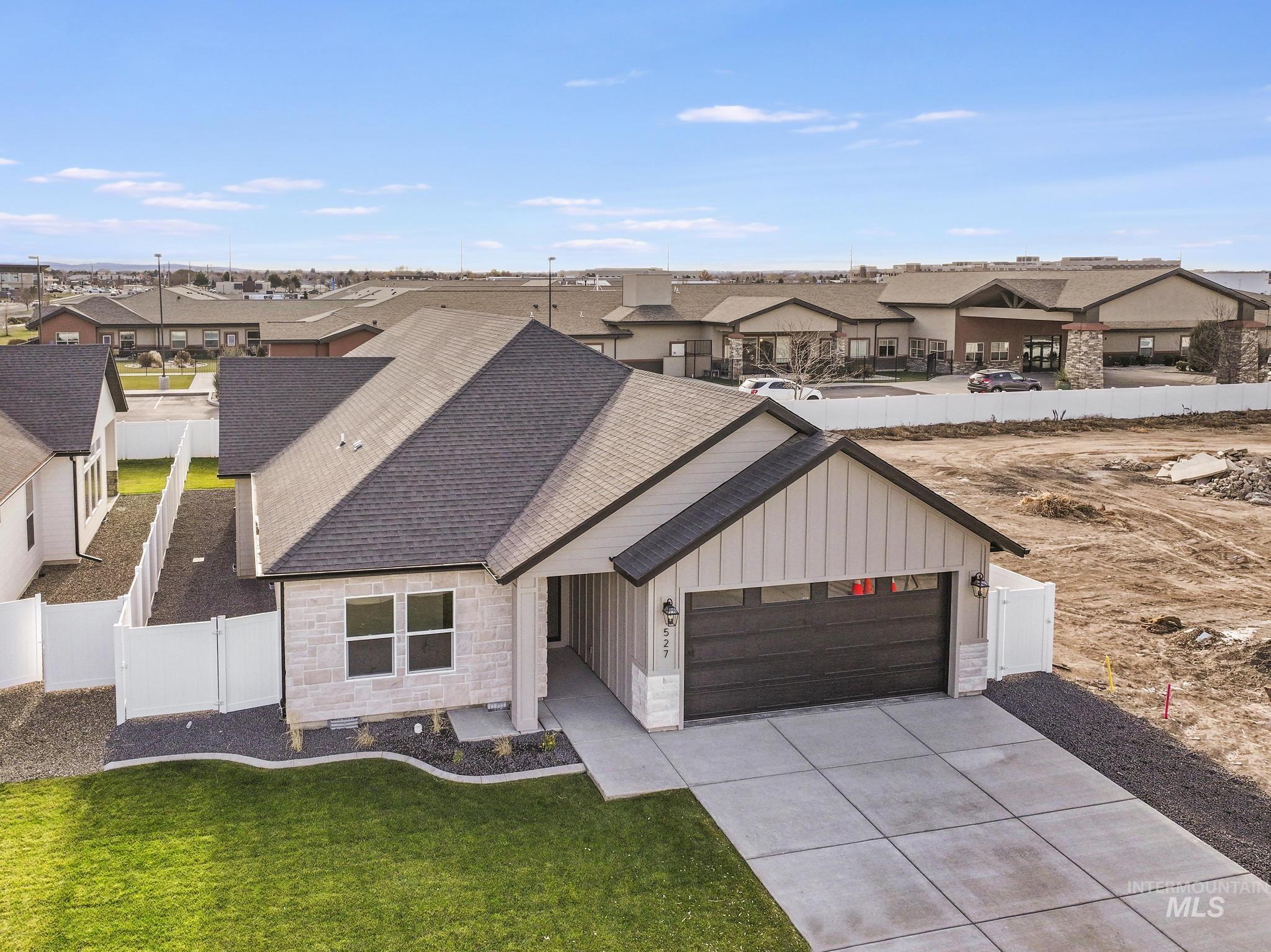 527 Falling Leaf Lane Twin Falls, ID 83301 - Photo 38 of 42 View of front of home featuring a residential view, roof with shingles, board and batten siding, and stone siding