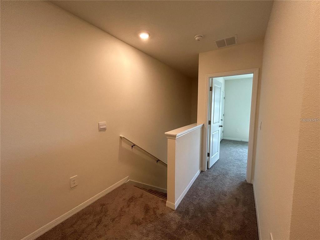 17550 Crescent Moon Loop Bradenton, FL 34211 - Photo 13 of 36 a view of a hallway with white walls