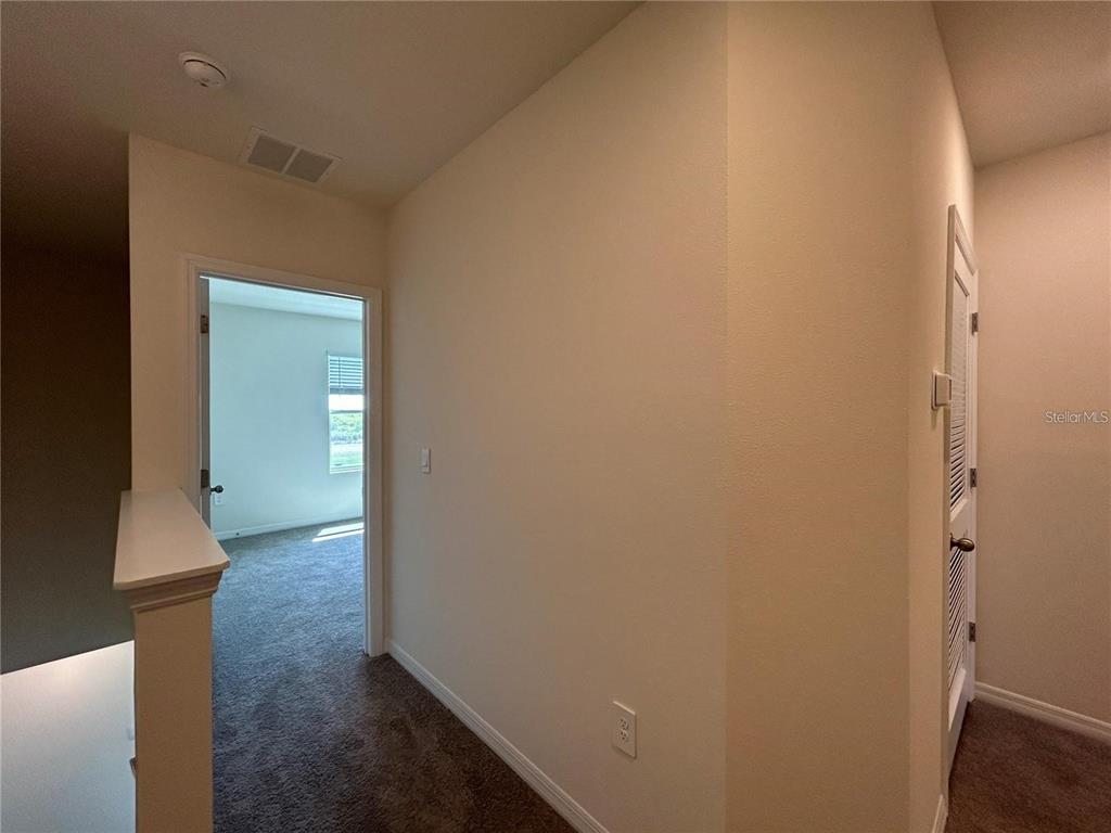 17550 Crescent Moon Loop Bradenton, FL 34211 - Photo 14 of 36 a view of hallway with livingroom