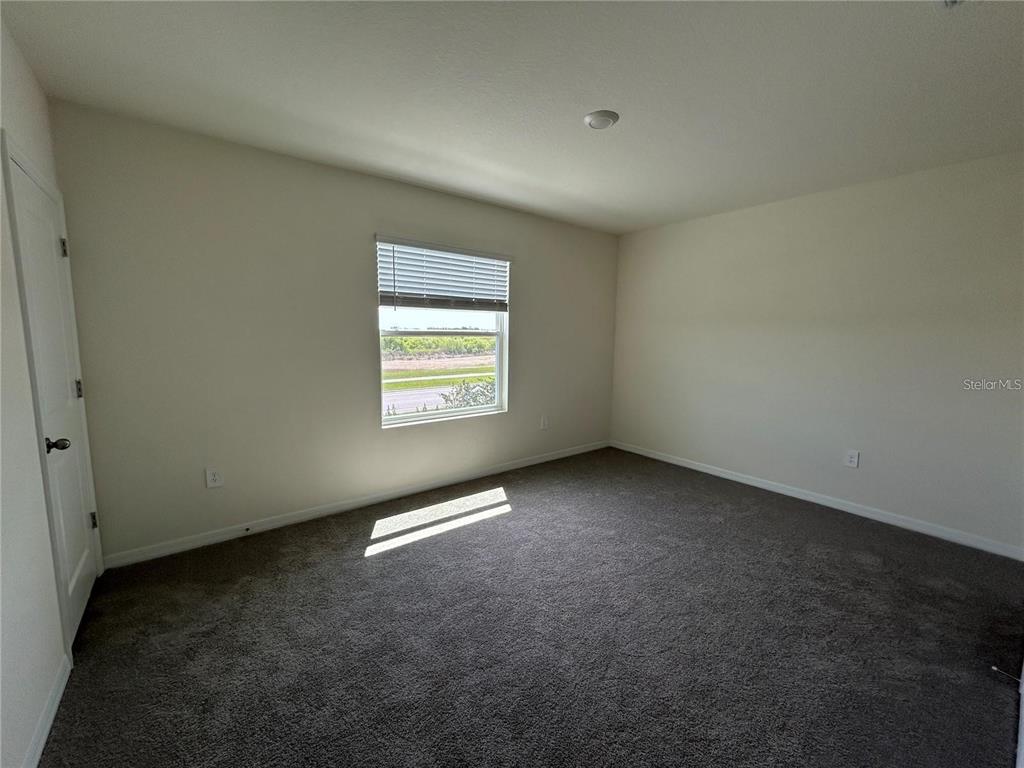17550 Crescent Moon Loop Bradenton, FL 34211 - Photo 15 of 36 an empty room with a empty space and window