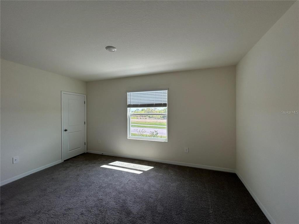 17550 Crescent Moon Loop Bradenton, FL 34211 - Photo 16 of 36 an empty room with a window