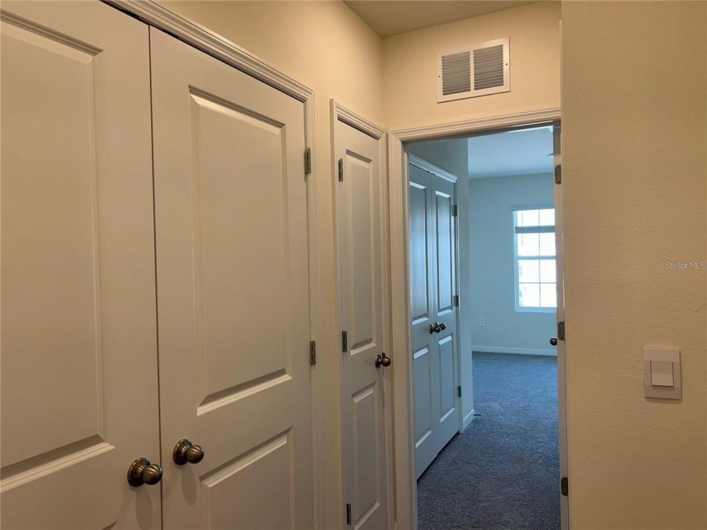 17550 Crescent Moon Loop Bradenton, FL 34211 - Photo 23 of 36 a view of a hallway with wooden floor and closet area