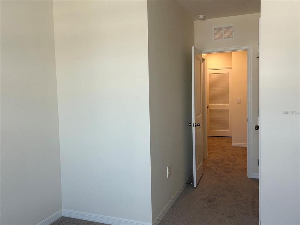 17550 Crescent Moon Loop Bradenton, FL 34211 - Photo 24 of 36 a view of a bathroom from a corridor