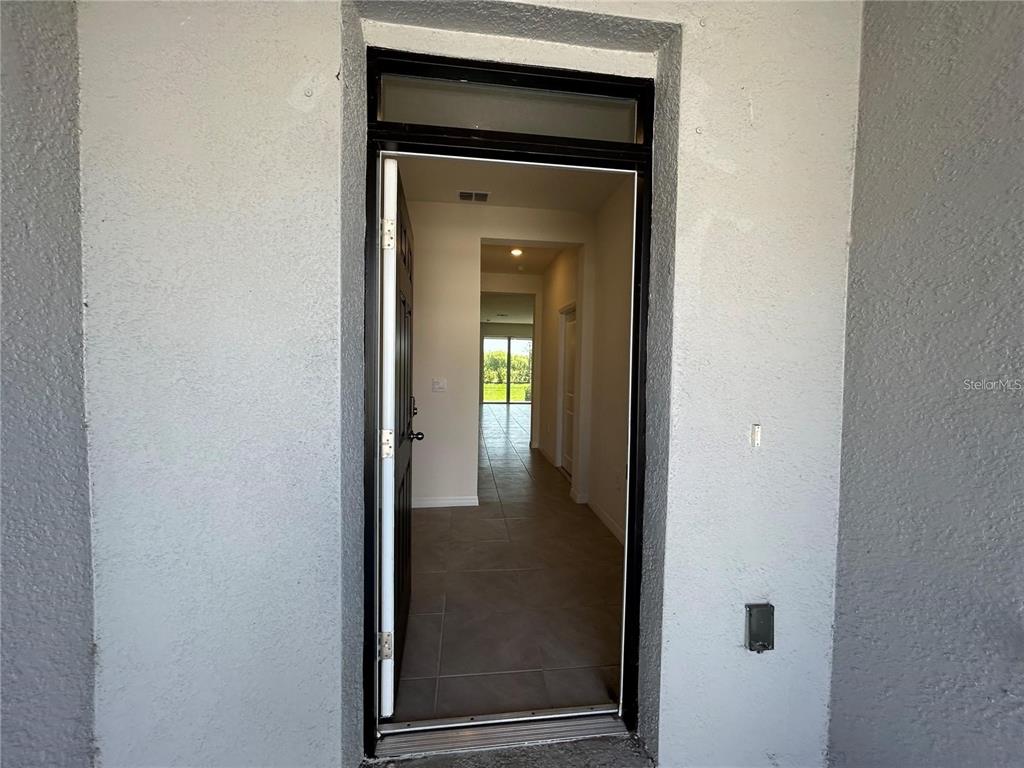 17550 Crescent Moon Loop Bradenton, FL 34211 - Photo 3 of 36 a view of a livingroom from a hallway