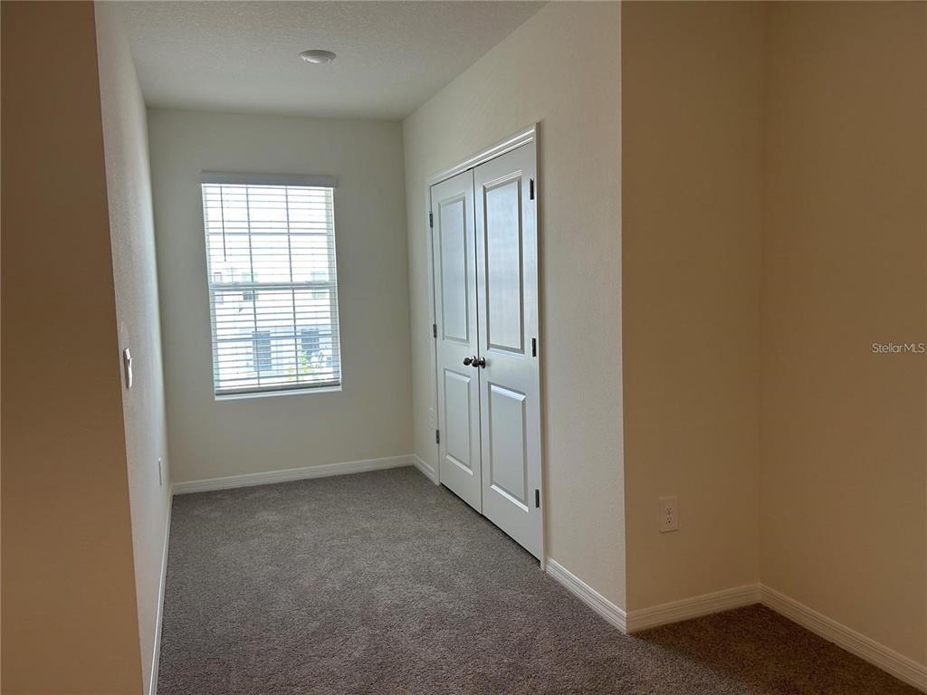 17550 Crescent Moon Loop Bradenton, FL 34211 - Photo 32 of 36 an empty room with windows