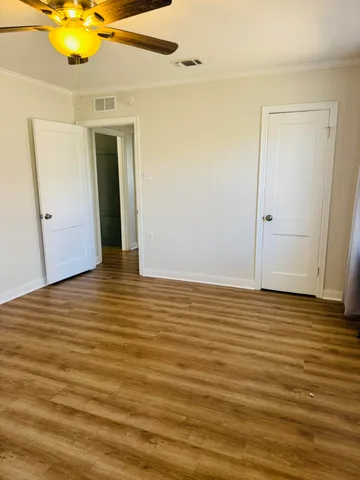 a view of a room with wooden floor