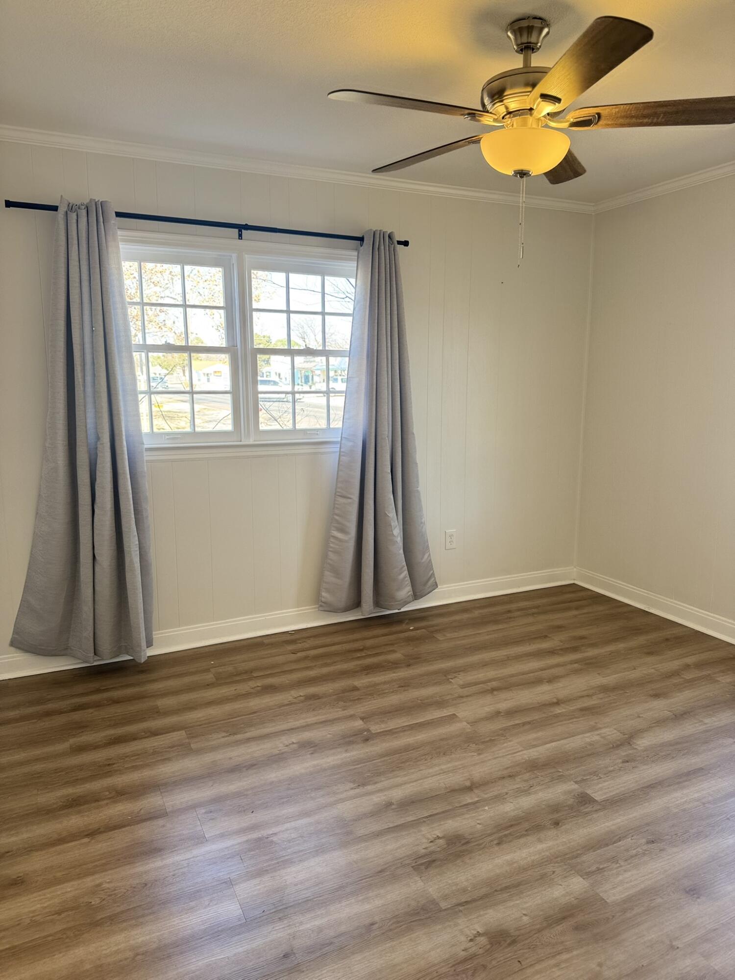 2701 27th Street Lubbock, TX 79410 - Photo 13 of 17 a view of empty room with wooden floor and fan