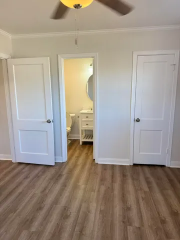 a view of empty room with wooden floor and cabinet