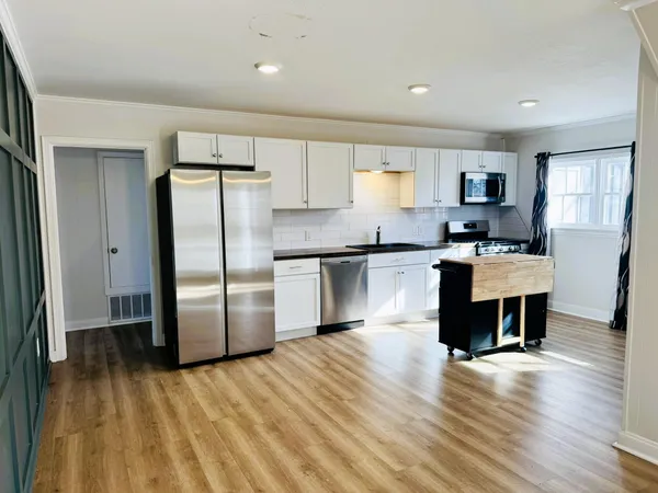 a kitchen with a refrigerator and a sink