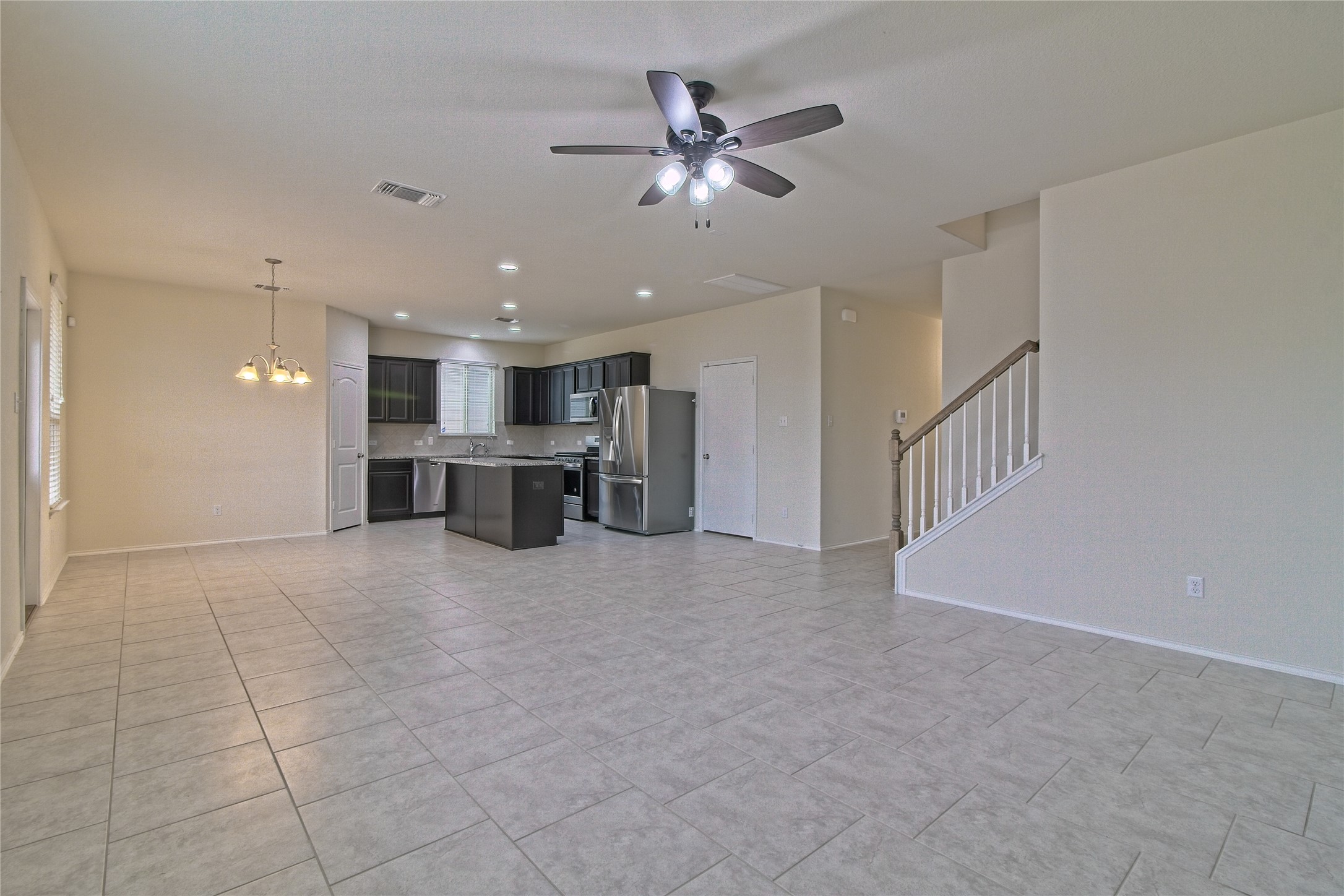 521 Staton Street Georgetown, TX 78626 - Photo 3 of 39 a view of a livingroom with a ceiling fan and kitchen view
