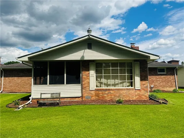 a house that has a big yard in front of it