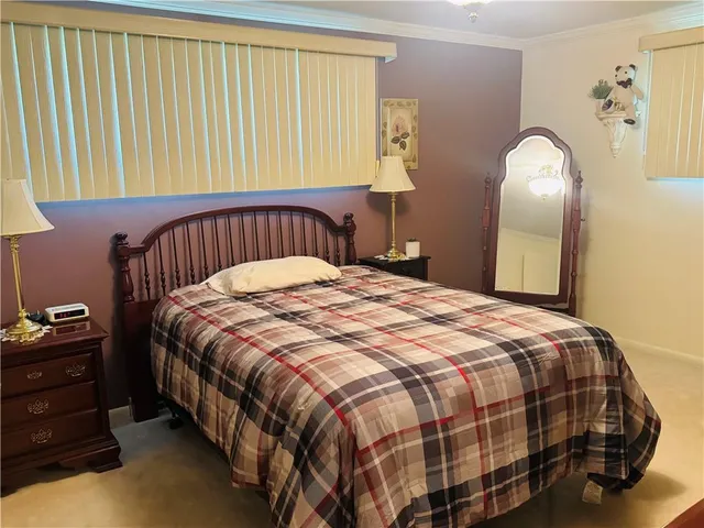 a bedroom with a bed and dresser