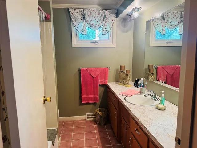a bathroom with a sink vanity and toilet