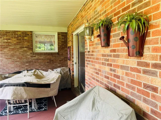 a balcony with table and chairs