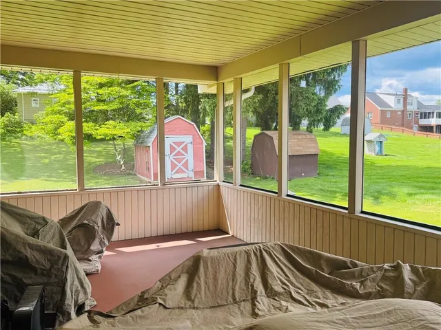 a view of a balcony with floor to ceiling windows with wooden floor