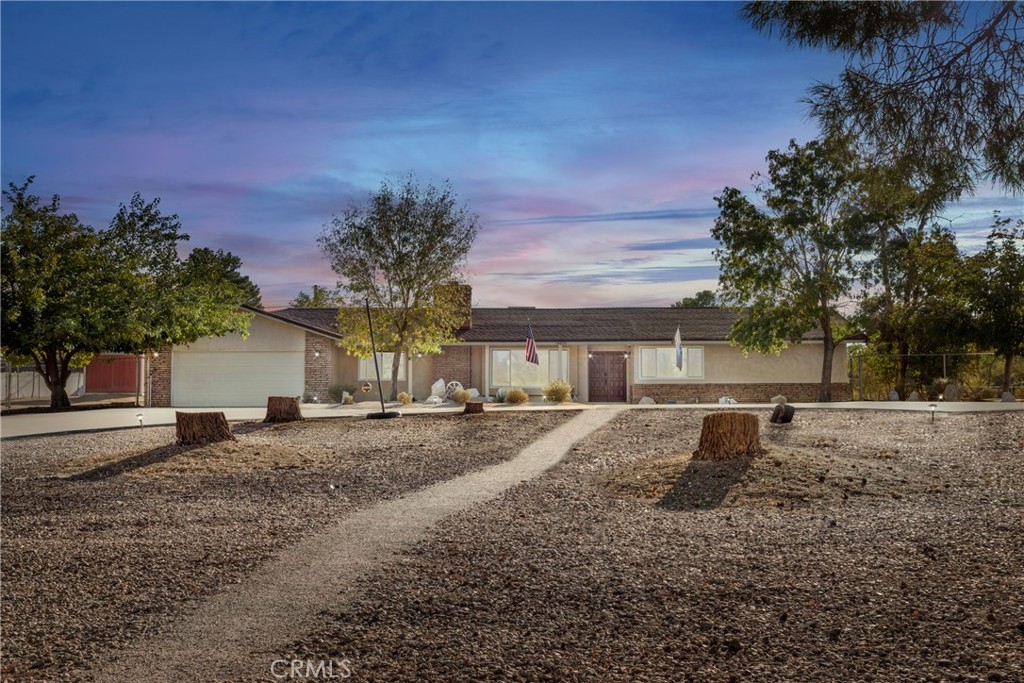 19425 Yanan Road Apple Valley, CA 92307 - Photo 1 of 1 a view of a house with a yard and garage